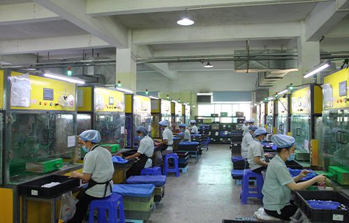 "Workers at KING DA factory using advanced spraying technology for even, durable coatings on plastic products."